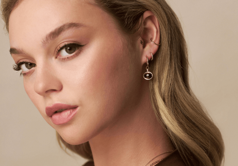 Model wearing a full ear stack featuring cartilage piercing jewellery