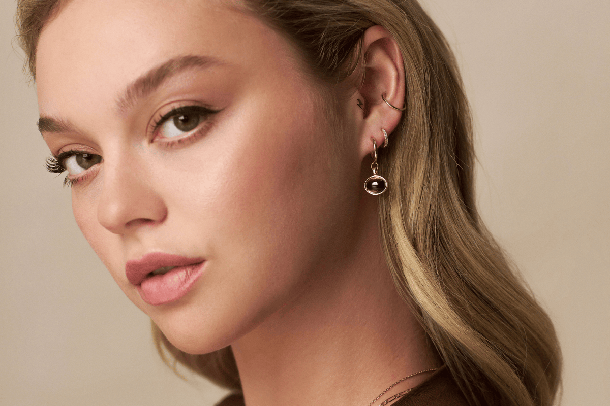 Model wearing a full ear stack featuring cartilage piercing jewellery