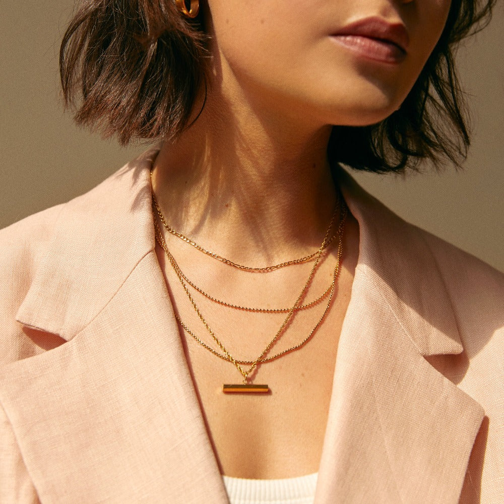 Gold t bar necklace meaning sale